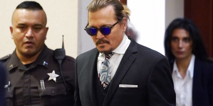 Actor Johnny Depp appears in the courtroom at the Fairfax County Circuit Courthouse in Fairfax, Va., Monday April 18, 2022. Depp sued his ex-wife Amber Heard for libel in Fairfax County Circuit Court after she wrote an op-ed piece in The Washington Post in 2018 referring to herself as a "public figure representing domestic abuse." (AP Photo/Steve Helber, Pool)